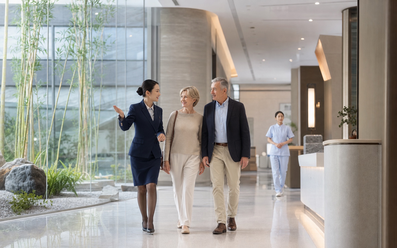 Chinese international patient coordinator welcoming an overseas couple in a modern hospital in China